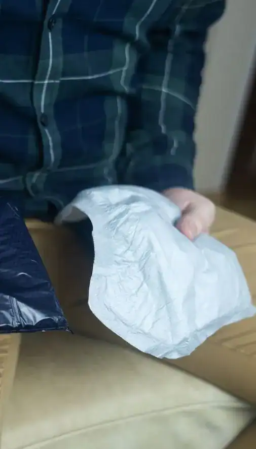 Image of man holding incontinence pads as part of overactive bladder treatment Chelmsford