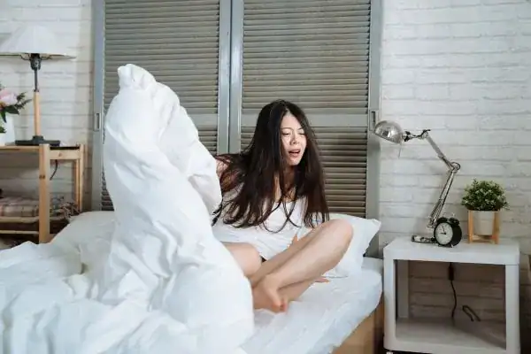 Image of woman getting up because of nighttime leaks Chelmsford